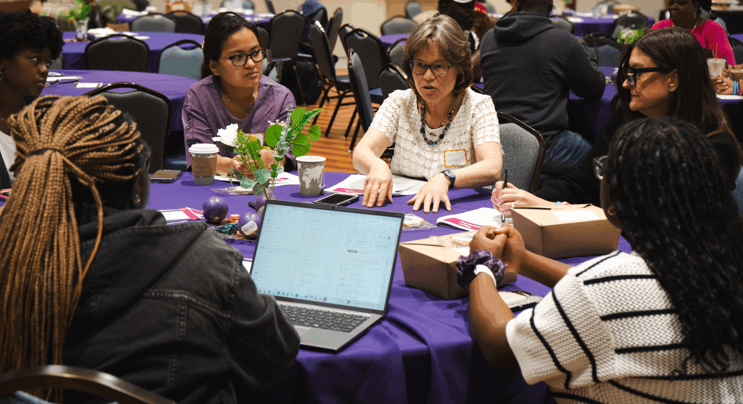 Group of people at the Healthy Start Summit in a vibrant discussion